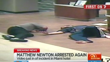 Hotel CCTV....Matthew Newton, right, is seen rolling on the floor alongside the hotel clerk, who appears injured in footage released by US police.