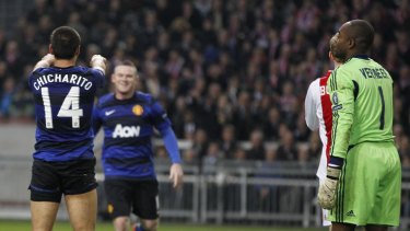 Manchester United's Mexican player Javier "Chicharito" Hernandez (left) celebrates with Wayne Rooney (background) after scoring during the Europa League match against Ajax Amsterdam.