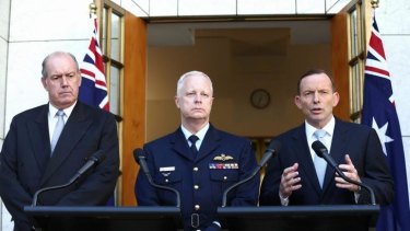 Prime Minister Tony Abbott, with Senator Johnston and Air Chief Marshal Mark Binskin, in Canberra on Friday.