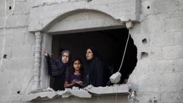Palestinians survey the damage from a window in Rafah after the ceasefire failed and bombardment resumed on Saturday.