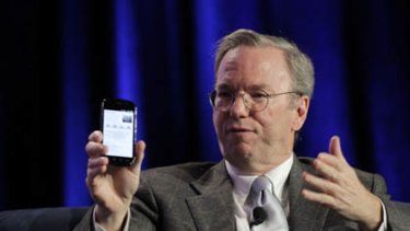 Google CEO Eric Schmidt holds a prototype of the Android Gingerbread smartphone during the Web 2.0 Summit in San Francisco, California November 15, 2010.