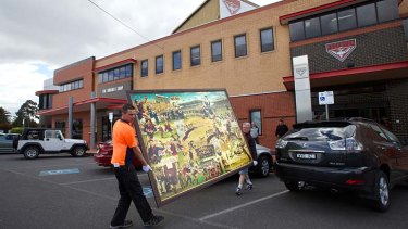 New home: Removalists transport the painting <em>When We Played Football</em> at Windy Hill.