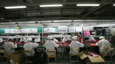 Workers are seen inside a Foxconn factory in the township of Longhua in the southern Guangdong province.
