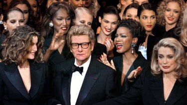 Yves Saint-Laurent took his final fashion bow in 2002 flanked by models and French actress Catherine Deneuve