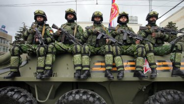 Pro-Russian separatists of the self-proclaimed Donetsk People's Republic sit on a self-propelled gun in Donetsk last weekend.