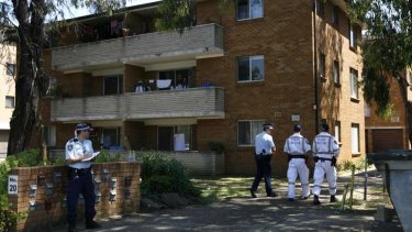 Police inspect the Canley Vale apartment block after the stabbing on New Year's Day, 2011.