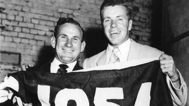 Charlie Sutton and Ted Whitten with the 1954 premiership flag.