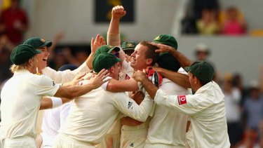 Mobbed . . . Peter Siddle is surrounded by his teammates after claiming a hat-trick.