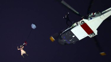 One giant leap ... 'the Queen' jumps from a helicopter during the Bond sequence.