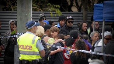 Premier Anna Bligh with family and friends of the 11 people who are believed to have been killed at a house fire overnight in Slacks Creek, south of Brisbane.