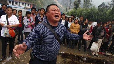Grieving: A man weeps for his child who was killed when the Beichan middle school collapsed during the 2008 earthquake.