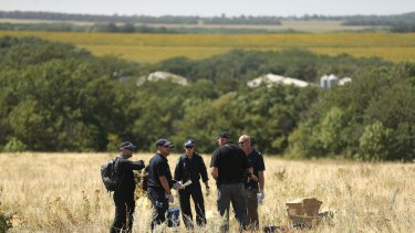Australian Federal Police and their Dutch counterparts searching at the MH17 crash site.
