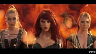 The <i>Bad Blood</i> video clip features Swift and her friends such as supermodels Gigi Hadid (L) and Martha Hunt (R).