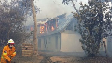 Firefighters try to save a house at Katoomba.