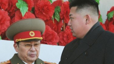 North Korean leader Kim Jong-un walks past his uncle, Jang Song-thaek, at a military parade in February last year.