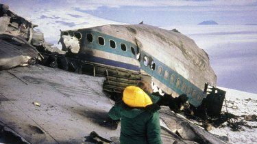 A rescue worker walks past the wreckage of the Air New Zealand DC10 plane after it crashed into Mount Erebus in Antarctica on Novdember. 28, 1979, killing all 257 on board.