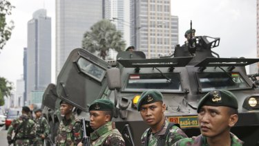 Indonesian soldiers stand guard in Central Jakarta, Indonesia on Thursday.