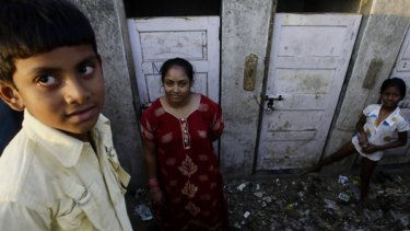 Shah Rukh Munshi, 11 (left), who acted in  Slumdog Millionaire  and his mother, Regina Munshi, 28, near their slum home.