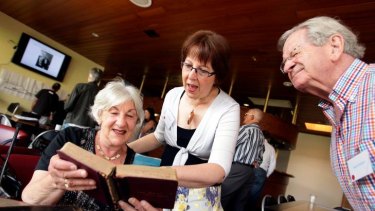The Solomon family reunion in Caulfield, Melbourne where Beverley Gorr, Jenny Cowan and  David Graham look through some old cooking books.