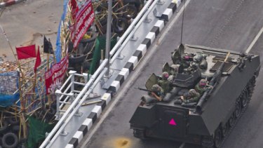 Thai troops aboard an armoured personnel carrier take aim at anti-government protesters in Lumpini Park in downtown Bangkok.