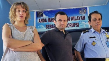 Jailed: French journalists Valentine Bourrat and Thomas Dandois pictured with an Indonesian immigration official in Papua.