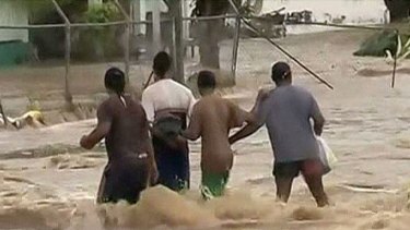 Flood crisis ... Fiji locals struggle against the water.