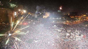 Protesters set-off fireworks as they gather in Tahrir Square in Cairo.