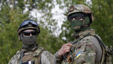 Ukrainian servicemen guard a checkpoint near the eastern Ukrainian town of Debaltseve.