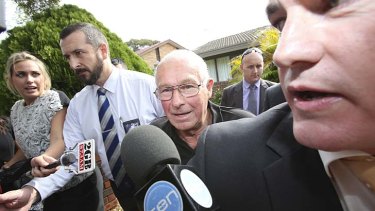 Arrested: Detectives lead Roger Rogerson from his Padstow Heights home.