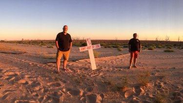 Darryn Clifton and mate Ross Leddra on the shore of Lake Menindee, at the village of Sunset Strip. When the lake is full, the water would be up to their shoulders on the shore line. 