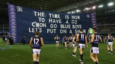 Carlton players walk out in white shorts when they should have been wearing blue shorts instead.