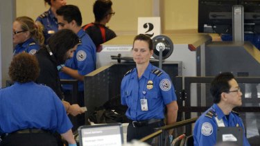 Easy targets: Transportation Security Administration agents in Los Angeles International Airport's Terminal 3 after it was re-opened on Saturday.