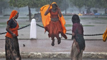 A moment of joy for some, as women in New Delhi enjoy the arrival of monsoonal rains.