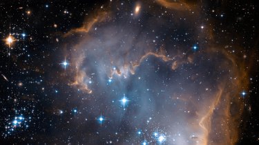 This image, shot by the Hubble Telescope, shows a portion of the Small Magellanic Cloud. Other galaxies, many more light-years away, are also visible in the background.