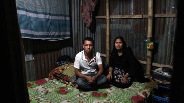 Forhad Mia and his wife Raifa sit in their slum bedsit in the Bangladeshi capital Dhaka.