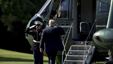 US President Donald Trump salutes before boarding Marine One on Wednesday as he faces the deepest crisis of his presidency after a memo alleged he asked for the investigation into Flynn to be dropped. 