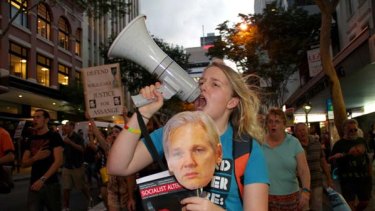 Kat Henderson makes her displeasure known as she joins supporters of Julian Assange, the Wikileaks founder, at a rally in Brisbane.