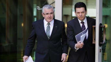 Independent MP Andrew Wilkie, left, and independent Senator Nick Xenophon. Mr Wilkie has threatened to vote against the government's poker machine reform bill because he says they are too weak.