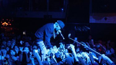 A music fan using a selfie stick at a concert in Toronto, Canada.