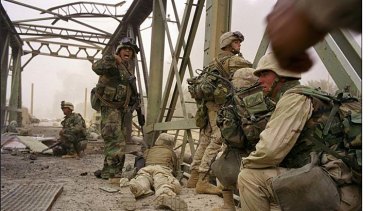 Danger and confusion: Marines cross a bridge over the Diyala River, heading towards Baghdad in the invasion of Iraq.