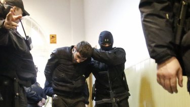 Zaur Dadayev is 'escorted' inside a court building in Moscow last Sunday.