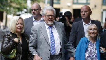 Rolf Harris arrives with his daughter Bindi, left,  and wife Alwen, right, at Southwark Crown Court in London.