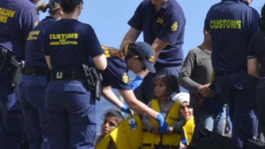 End of a desperate journey ... a small girl is among the 160 asylum seekers taken to safety on Christmas Island on Wednesday.