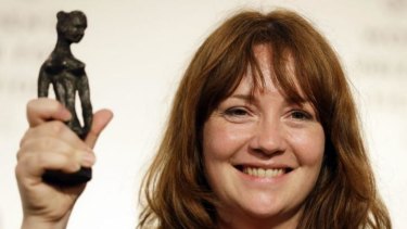 Impressive debut ... Author Eimear McBride who wrote the novel <i>A Girl is a Half-Formed Thing</i>, holds the trophy on stage after winning The Baileys Women's Prize for Fiction at an awards ceremony at the Royal Festival Hall in London.