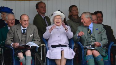 Prince Philip (left), the Queen and Prince Charles in Braemar, Scotland, in 2012.