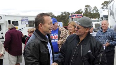 To address truck drivers' rally &#8230; the Opposition Leader, Tony Abbott, meets convoy protester Ken Wilkie at Marulan near Canberra yesterday.