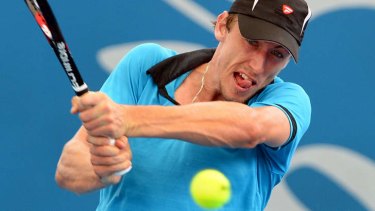 John Millman of Australia hits a backhand return on the way to victory over Tatsuma Ito of Japan in the first round at the Brisbane International.