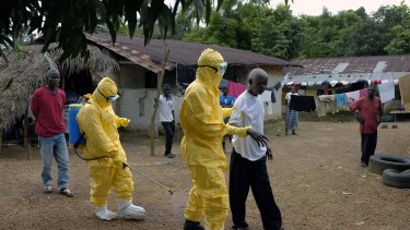 Yarkpawoto Paye, 84, is taken to an ambulance after showing signs of Ebola infection in the village of Freeman Reserve, about 50 kilometres north of Monrovia, Liberia.