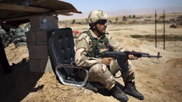 A Kurdish Peshmerga fighter holds a position.