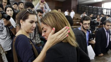 The fiancee of journalist Mohamed Fahmy is consoled by a friend following the verdicts in the sentencing hearing for al-Jazeera journalists.